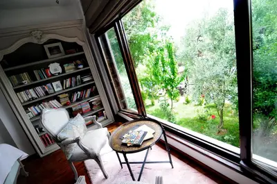 a living room with a large window and a table and chairs at Beyaz Ev Agva - Adult only +15 in Agva