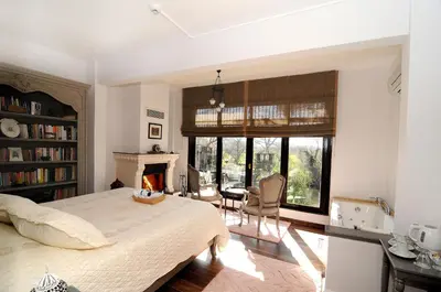 a bedroom with a bed and a fireplace at Beyaz Ev Agva - Adult only +15 in Agva