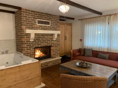 a living room with a fireplace and a tub at Beyaz Ev Agva - Adult only +15 in Agva
