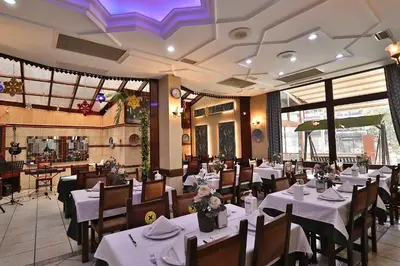 a restaurant with tables and chairs with white tablecloths at Blue House Hotel Old City - Sultanahmet in Istanbul