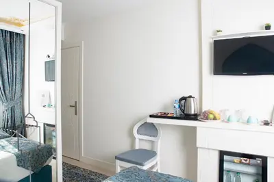 a living room with a fireplace and a tv at KRALICE HOTEL in Istanbul