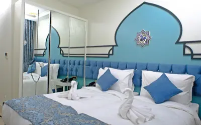 a blue bedroom with a bed with two swans on it at KRALICE HOTEL in Istanbul