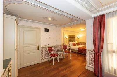 a hotel room with a bed and a table and chairs at Meserret Palace Hotel - Special Category in Istanbul