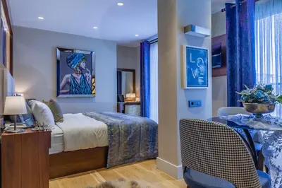 a bedroom with a bed and a table and chairs at Lord Morgan & Exclusive Design Residence Cihangir in Istanbul