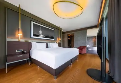 a bedroom with a large white bed and a large mirror at Radisson Collection Hotel, Vadistanbul in Istanbul
