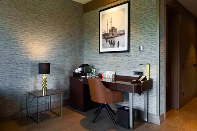 a hotel room with a desk and a chair at Radisson Collection Hotel, Vadistanbul in Istanbul