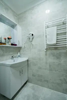 a white bathroom with a sink and a shower at ATAM HOTEL in Istanbul