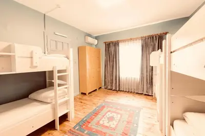 a room with two bunk beds and a window at Cheers Midtown Hostel in Istanbul