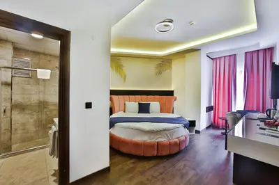 a hotel room with a bed and a shower at Kavala Hotel in Bursa