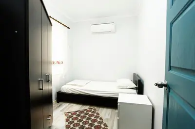 a small bedroom with a bed and a door at Blue Suites by V in Istanbul