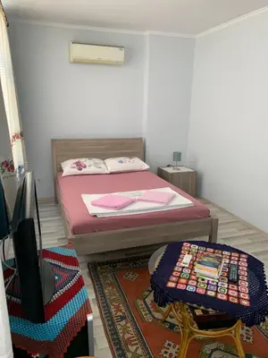 a small bedroom with a bed and a table at Blue Suites by V in Istanbul