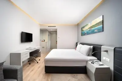 a hotel room with a bed and a desk at Ramada Plaza by Wyndham Istanbul Atakoy in Istanbul