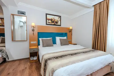 a bedroom with a large bed with a blue headboard at Seatanbul Hotel in Istanbul