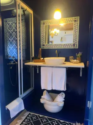 a bathroom with a sink and a toilet and a mirror at Tom Square Boutique Hotel in Istanbul