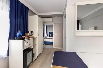 a small room with a bed and a mirror at Sirkeci Grand Family Hotel & SPA in Istanbul