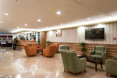 a waiting room with chairs and a flat screen tv at DİNAR HOTEL in Istanbul