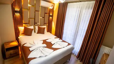 a hotel room with a bed with towels on it at La Fortuna Taksim Hotel in Istanbul