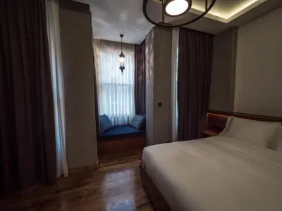a bedroom with a bed and a window with a couch at Blu Hotel in Istanbul
