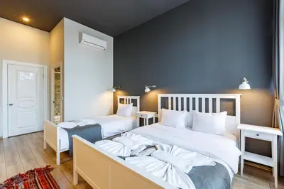 a bedroom with two beds and a blue wall at Hotel Miro Mansion Old City in Istanbul