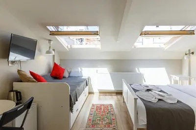 a attic bedroom with two beds and a tv at Hotel Miro Mansion Old City in Istanbul