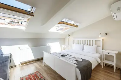 a bedroom with a white bed in a room with skylights at Hotel Miro Mansion Old City in Istanbul