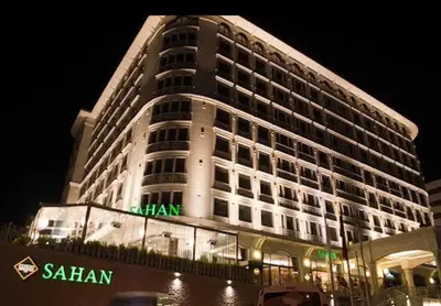 a large building with a sign on it at night at FALCON PalaS OTEL in Istanbul