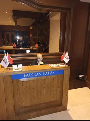a man sitting at a desk behind a podium at FALCON PalaS OTEL in Istanbul