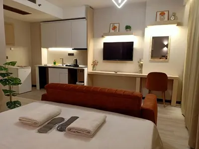 a room with a couch and a table with towels at FALCON PalaS OTEL in Istanbul