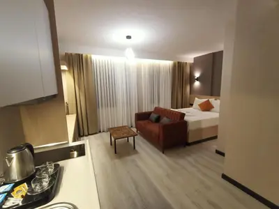 a hotel room with a bed and a couch at FALCON PalaS OTEL in Istanbul
