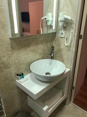 a bathroom with a white sink and a mirror at The Void Hotel in Istanbul