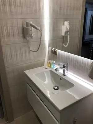 a bathroom with a white sink and a mirror at Hotel The Pera Hill in Istanbul