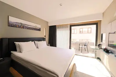 a hotel room with a large bed and a balcony at Inncity Hotel Nisantasi in Istanbul