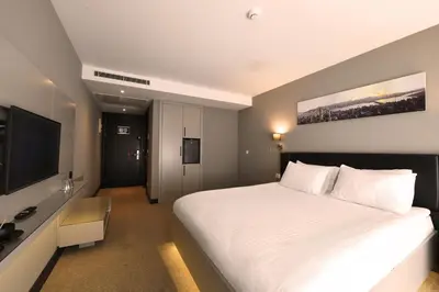 a bedroom with a large bed and a flat screen tv at Inncity Hotel Nisantasi in Istanbul
