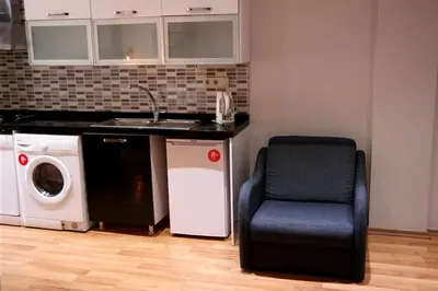 a kitchen with a chair and a sink and a dishwasher at Sheriff Residence in Istanbul