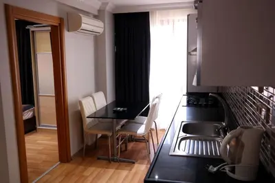 a kitchen and dining room with a table and chairs at Sheriff Residence in Istanbul