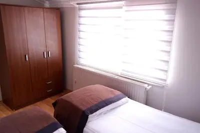 a bedroom with a bed and a window with blinds at Sheriff Residence in Istanbul