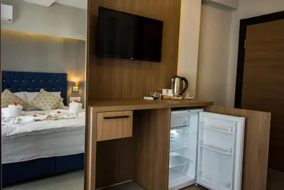 a bedroom with a bed and a tv on a wall at Hit Suites Avcilar Hotel in Avcılar