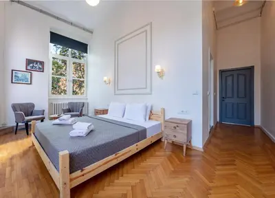 a bedroom with a bed and a chair and a window at Cezayir Rooms in Istanbul