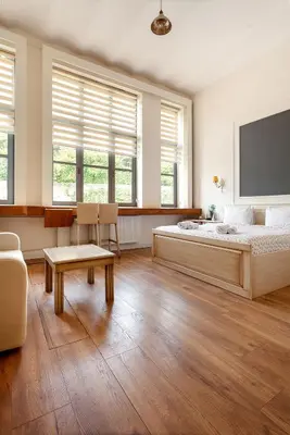 a bedroom with a large bed and two windows at Cezayir Rooms in Istanbul