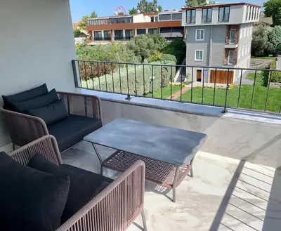 a balcony with a table and chairs and a view at Istanbul Park Hotel in Tuzla