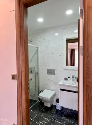 a bathroom with a toilet and a sink and a shower at Yankı Hotel in Çekirge