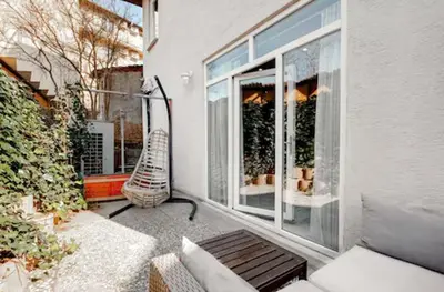 a balcony with a bench and a window with at Yankı Hotel in Çekirge