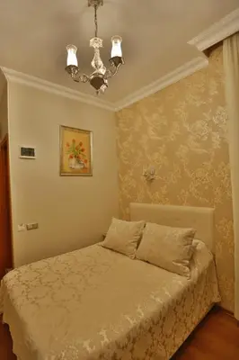 a bedroom with a bed and a chandelier at Mimoza Butik Otel Buyukada in Buyukada