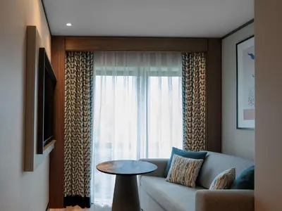 a living room with a couch and a window at Mercure Istanbul Altunizade in Istanbul