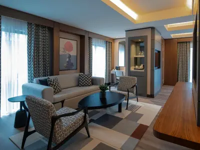 a living room with a couch and a table and chairs at Mercure Istanbul Altunizade in Istanbul