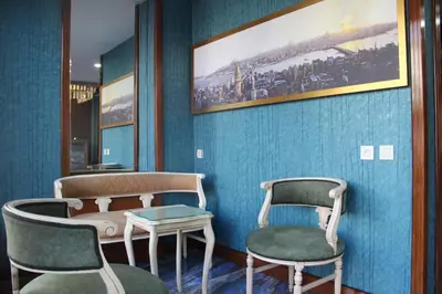 a room with two chairs and a bed and a table at Kaya Madrid Hotel in Istanbul