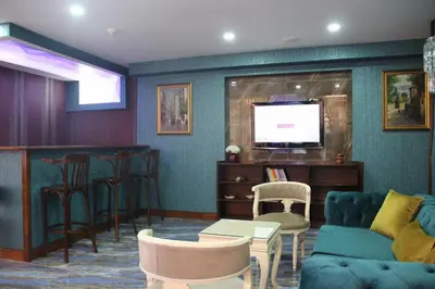 a living room with a couch and a bar at Kaya Madrid Hotel in Istanbul