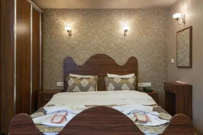 a bedroom with a bed with towels on it at Capricorn by Otantik Suites in Istanbul