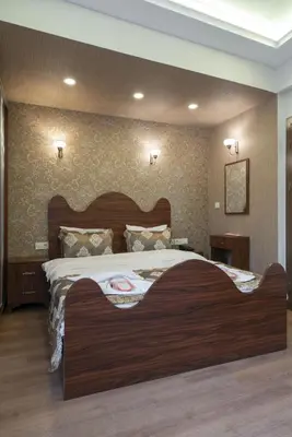a bedroom with a large wooden bed in a room at Capricorn by Otantik Suites in Istanbul