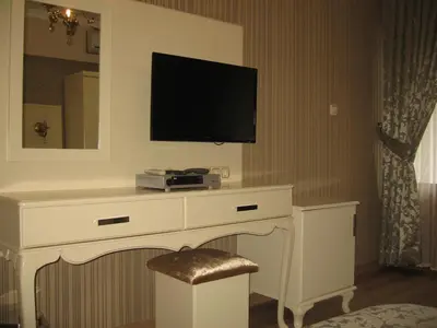 a room with a desk with a television on a wall at Termal Elit Hotel in Gokcedere